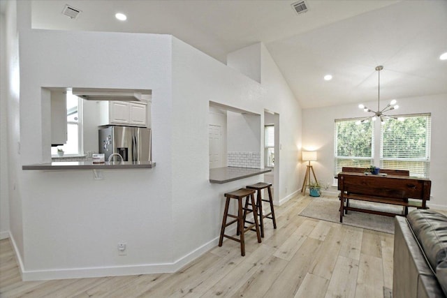 2208 Mimosa Trl, Round Rock, TX 78664 - living area featuring a chandelier, visible vents, light wood-style flooring, and baseboards