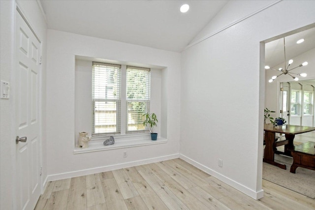 2208 Mimosa Trl, Round Rock, TX 78664 - unfurnished room featuring light wood-style flooring, an inviting chandelier, vaulted ceiling, and baseboards