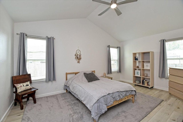 2208 Mimosa Trl, Round Rock, TX 78664 - bedroom featuring a ceiling fan, multiple windows, lofted ceiling, and light wood-type flooring