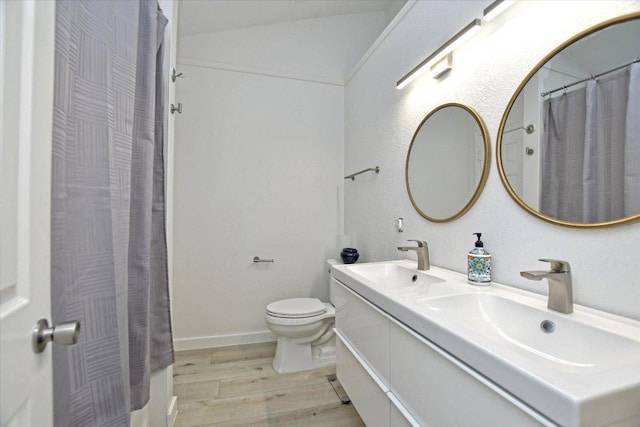 2208 Mimosa Trl, Round Rock, TX 78664 - full bathroom featuring toilet, double vanity, a sink, and wood finished floors