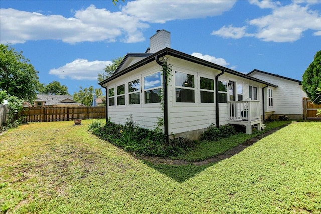 2208 Mimosa Trl, Round Rock, TX 78664 - view of side of property featuring a lawn, a fenced backyard, and a chimney