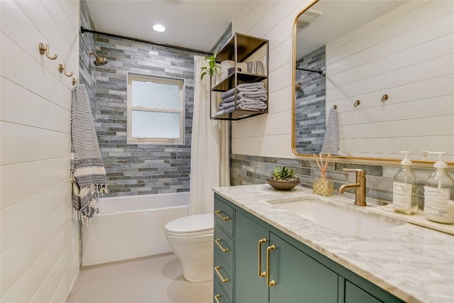 full bathroom featuring tile patterned floors, shower / bath combination with curtain, tile walls, toilet, and vanity