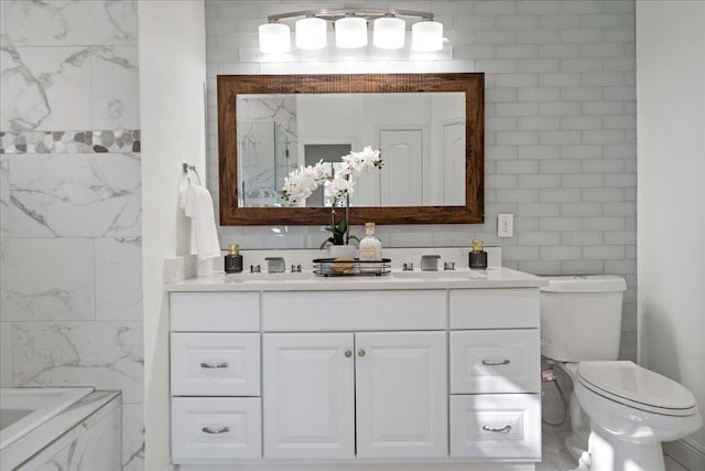 full bath featuring toilet, tile walls, a washtub, and vanity