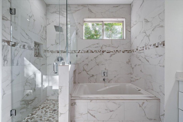 full bath featuring a marble finish shower and a bath