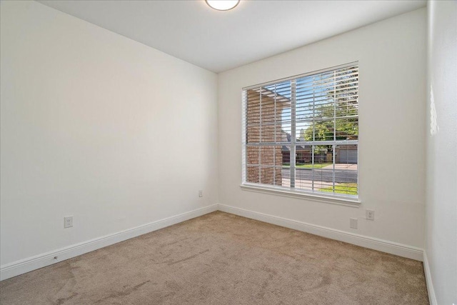 carpeted spare room with baseboards