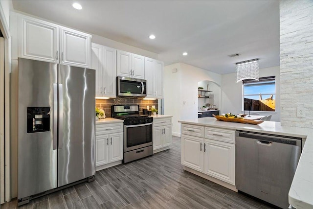 kitchen with white cabinetry, stainless steel appliances, and light countertops