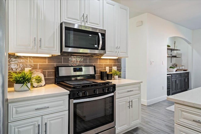 kitchen with white cabinets and appliances with stainless steel finishes