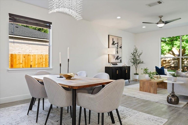 dining area with baseboards, visible vents, light wood-type flooring, and recessed lighting
