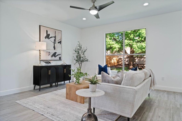 sitting room with baseboards, recessed lighting, wood finished floors, and a ceiling fan
