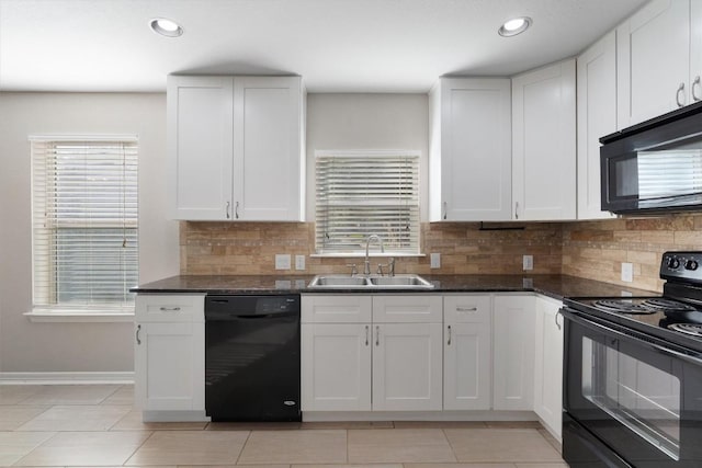 kitchen with black appliances, plenty of natural light, and a sink