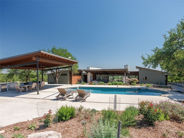 outdoor pool with a patio area