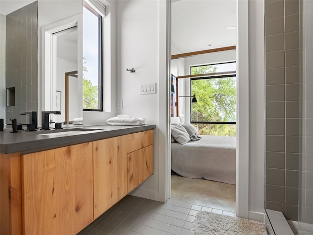 ensuite bathroom with vanity, ensuite bath, and tile patterned flooring