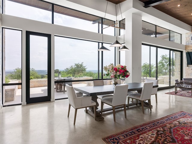 dining room featuring wooden ceiling, recessed lighting, a high ceiling, and plenty of natural light