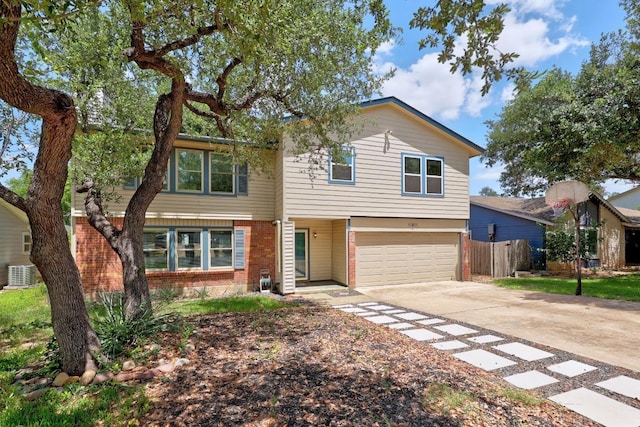11811 Buggy Whip Trl, Austin, TX 78750 - view of front of house with brick siding, driveway, central AC, and an attached garage