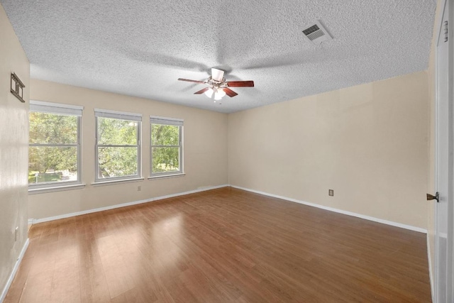 11811 Buggy Whip Trl, Austin, TX 78750 - empty room featuring ceiling fan, wood finished floors, a textured ceiling, and baseboards