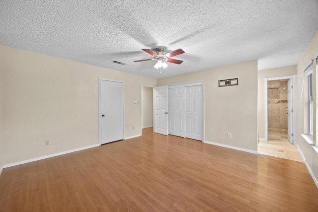 11811 Buggy Whip Trl, Austin, TX 78750 - unfurnished bedroom with light wood-style floors, baseboards, a textured ceiling, and ceiling fan
