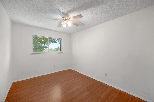 11811 Buggy Whip Trl, Austin, TX 78750 - empty room featuring wood finished floors, a ceiling fan, baseboards, and a textured ceiling