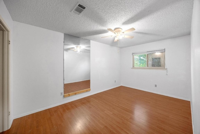 11811 Buggy Whip Trl, Austin, TX 78750 - empty room with a ceiling fan, wood finished floors, a textured ceiling, and baseboards