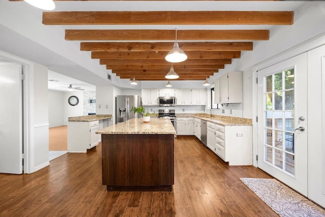 11811 Buggy Whip Trl, Austin, TX 78750 - kitchen featuring appliances with stainless steel finishes, a kitchen island, light stone counters, white cabinets, and beam ceiling