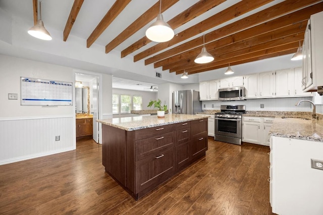 11811 Buggy Whip Trl, Austin, TX 78750 - kitchen featuring appliances with stainless steel finishes, a sink, a center island, beam ceiling, and dark wood-style flooring