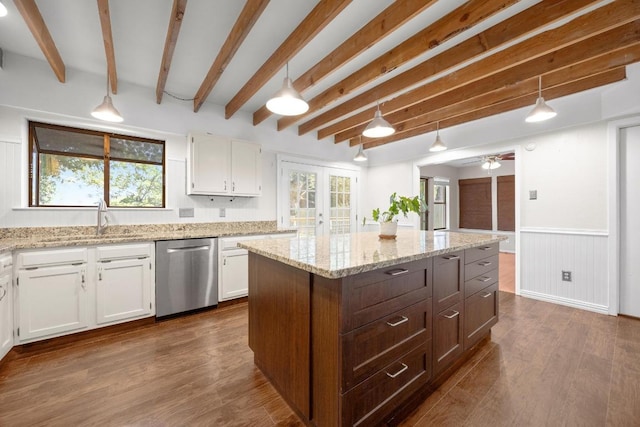 11811 Buggy Whip Trl, Austin, TX 78750 - kitchen with stainless steel dishwasher, a sink, white cabinets, beam ceiling, and a center island