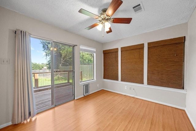 11811 Buggy Whip Trl, Austin, TX 78750 - empty room featuring wood finished floors, ceiling fan, baseboards, and a textured ceiling