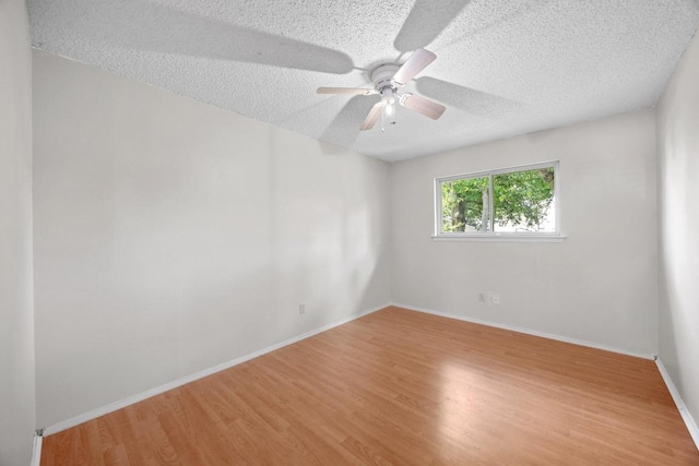 11811 Buggy Whip Trl, Austin, TX 78750 - unfurnished room featuring a textured ceiling, light wood finished floors, a ceiling fan, and baseboards
