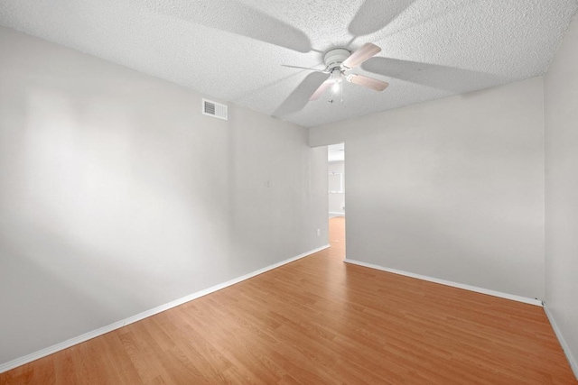 11811 Buggy Whip Trl, Austin, TX 78750 - spare room with a ceiling fan, baseboards, wood finished floors, and a textured ceiling