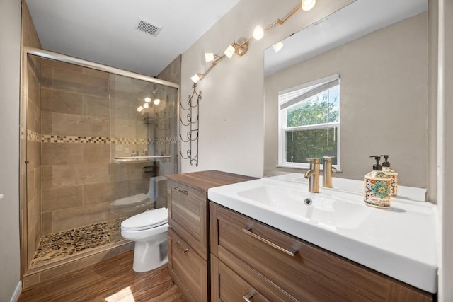 11811 Buggy Whip Trl, Austin, TX 78750 - bathroom featuring toilet, vanity, a stall shower, and wood finished floors