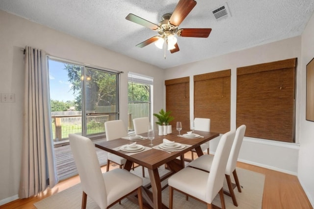 11811 Buggy Whip Trl, Austin, TX 78750 - dining area featuring light wood finished floors, a ceiling fan, a textured ceiling, and baseboards