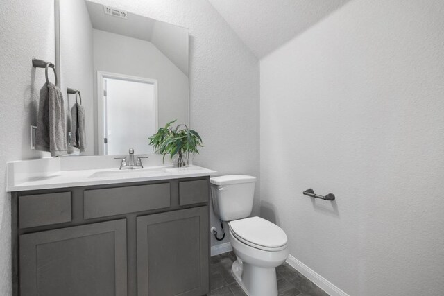 320 Creek Rd Unit 202, Dripping Springs, TX 78620 - half bath featuring toilet, vanity, a textured wall, and baseboards