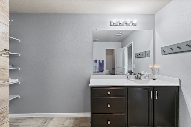 447 Discovery Dr, Kyle, TX 78640 - bathroom with vanity and baseboards