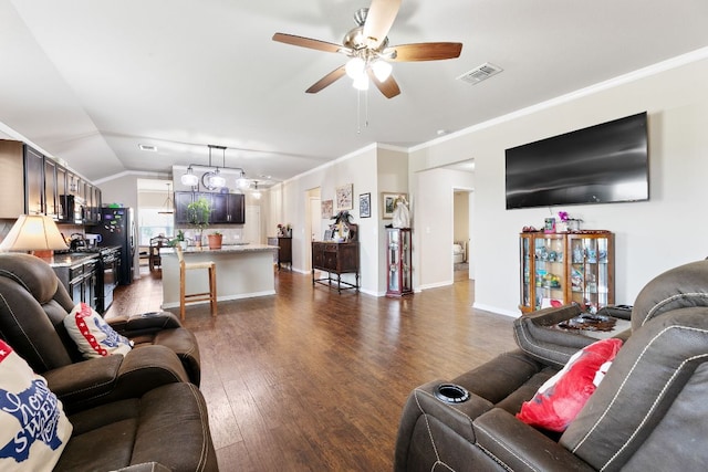447 Discovery Dr, Kyle, TX 78640 - living area with dark wood-style flooring, ceiling fan, lofted ceiling, and crown molding