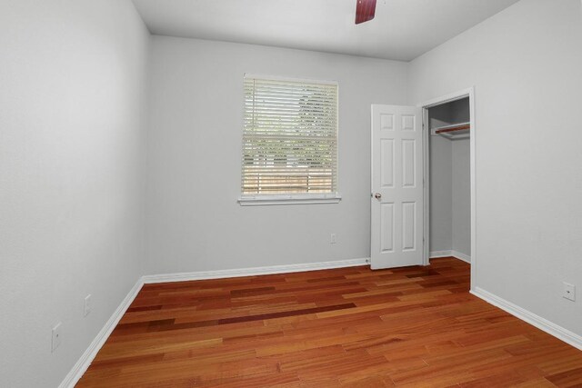 11100 Alison Parke Trl, Austin, TX 78750 - unfurnished bedroom featuring wood finished floors, baseboards, and ceiling fan