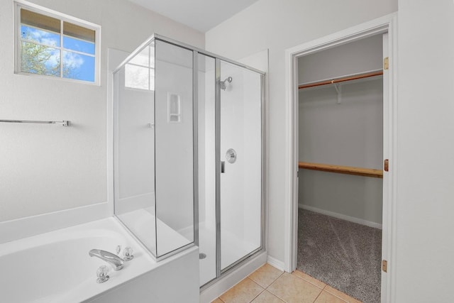 11100 Alison Parke Trl, Austin, TX 78750 - full bath featuring a stall shower, a walk in closet, tile patterned flooring, and a bath
