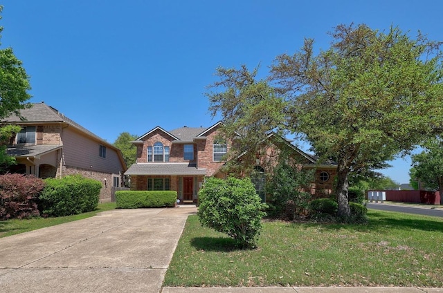 11100 Alison Parke Trl, Austin, TX 78750 - view of front facade with brick siding, a front lawn, and concrete driveway