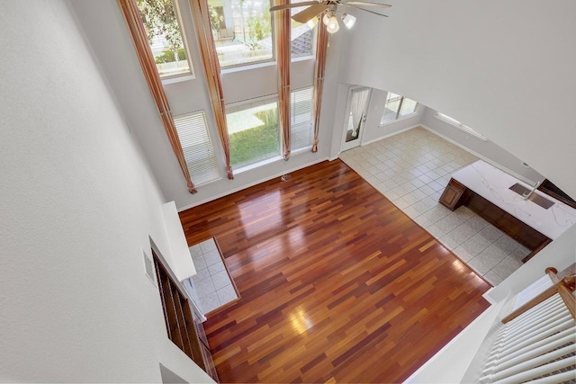 11100 Alison Parke Trl, Austin, TX 78750 - unfurnished living room featuring wood finished floors, ceiling fan, and a towering ceiling