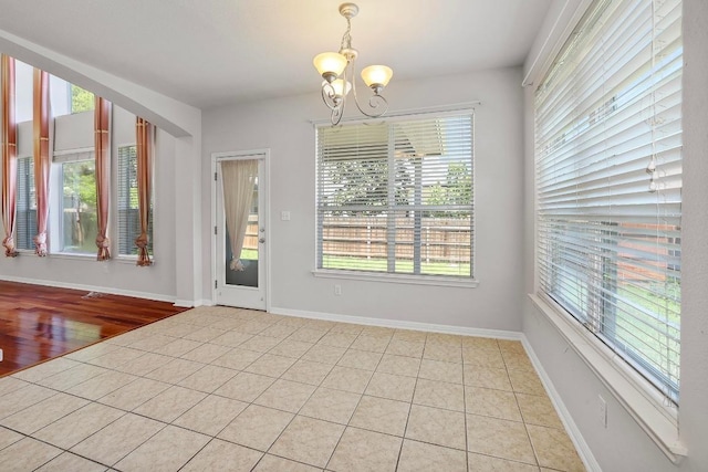 11100 Alison Parke Trl, Austin, TX 78750 - unfurnished dining area featuring a chandelier, light tile patterned floors, and baseboards