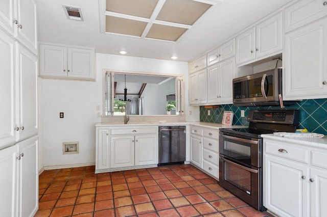 kitchen with tasteful backsplash, visible vents, stainless steel appliances, and light countertops