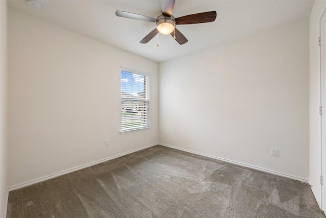 empty room featuring a ceiling fan, carpet floors, and baseboards