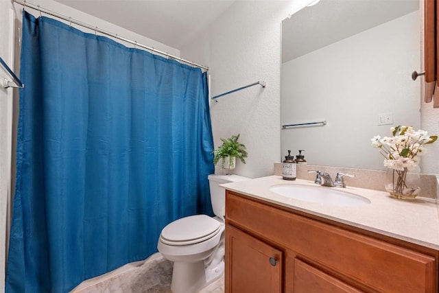 bathroom with toilet, curtained shower, vanity, and tile patterned flooring