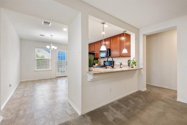 kitchen featuring an inviting chandelier, stove, brown cabinetry, black microwave, and visible vents