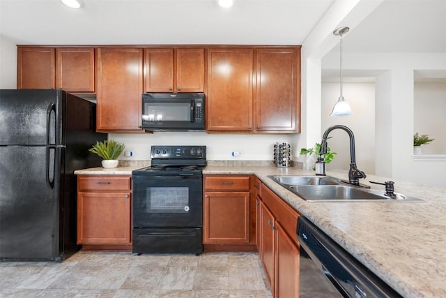 kitchen featuring black appliances, brown cabinets, light countertops, and a sink