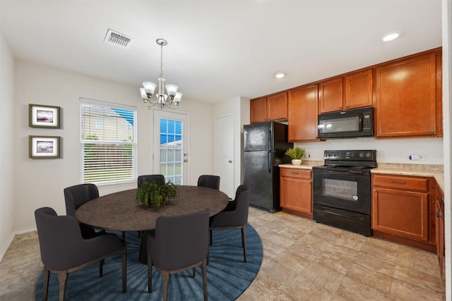 kitchen with black appliances, a chandelier, light countertops, and brown cabinetry