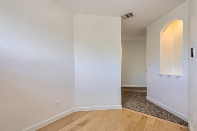 14308 Homestead Village Cir, Austin, TX 78717 - unfurnished room featuring light wood-style flooring, baseboards, and arched walkways