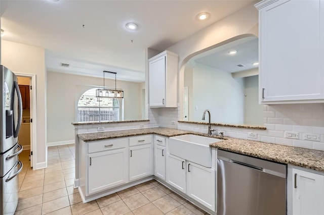 14308 Homestead Village Cir, Austin, TX 78717 - kitchen featuring stainless steel appliances, arched walkways, backsplash, a sink, and white cabinets