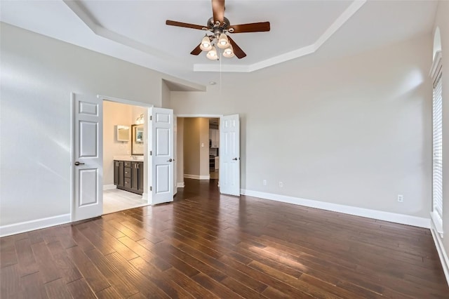 14308 Homestead Village Cir, Austin, TX 78717 - unfurnished bedroom with a tray ceiling, baseboards, hardwood / wood-style flooring, and ensuite bathroom