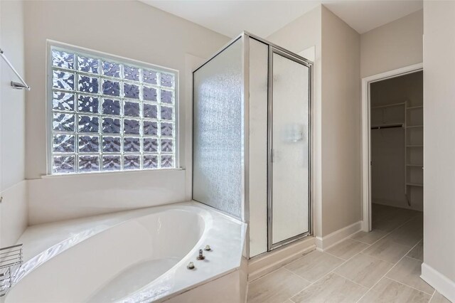 14308 Homestead Village Cir, Austin, TX 78717 - full bath with a shower stall, a bath, a walk in closet, and tile patterned floors