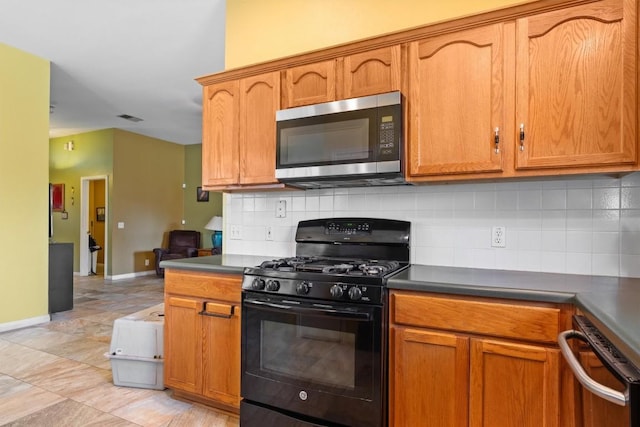 kitchen with baseboards, tasteful backsplash, stainless steel microwave, and gas stove