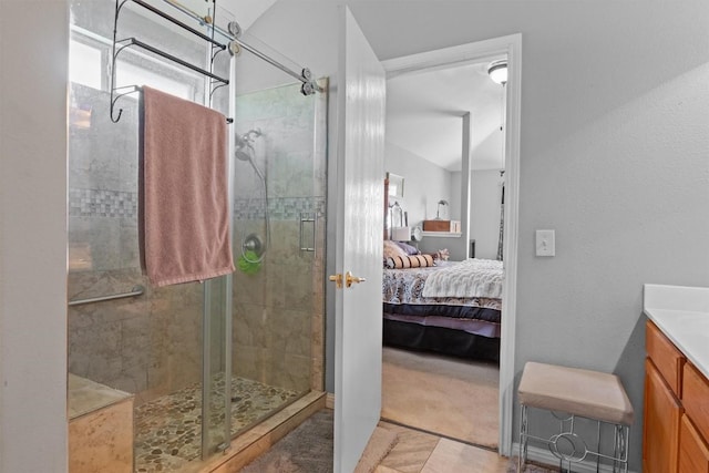 ensuite bathroom featuring vanity, ensuite bath, and a stall shower